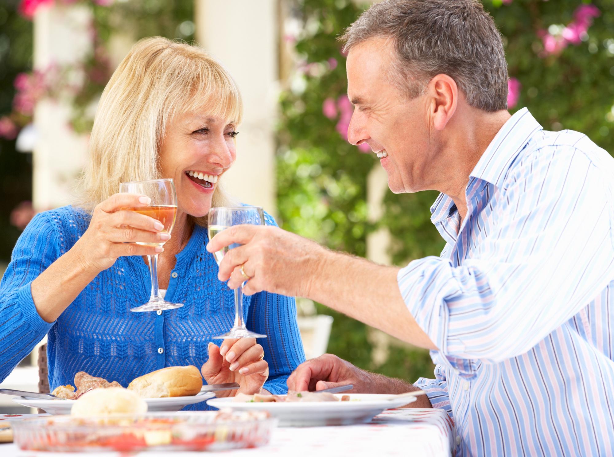 Empty Nesters Travel Guide to Travel without a Schedule: Embrace Freedom and Flexibility - Empty Nesters Enjoying a Relaxing Meal While on Vacation