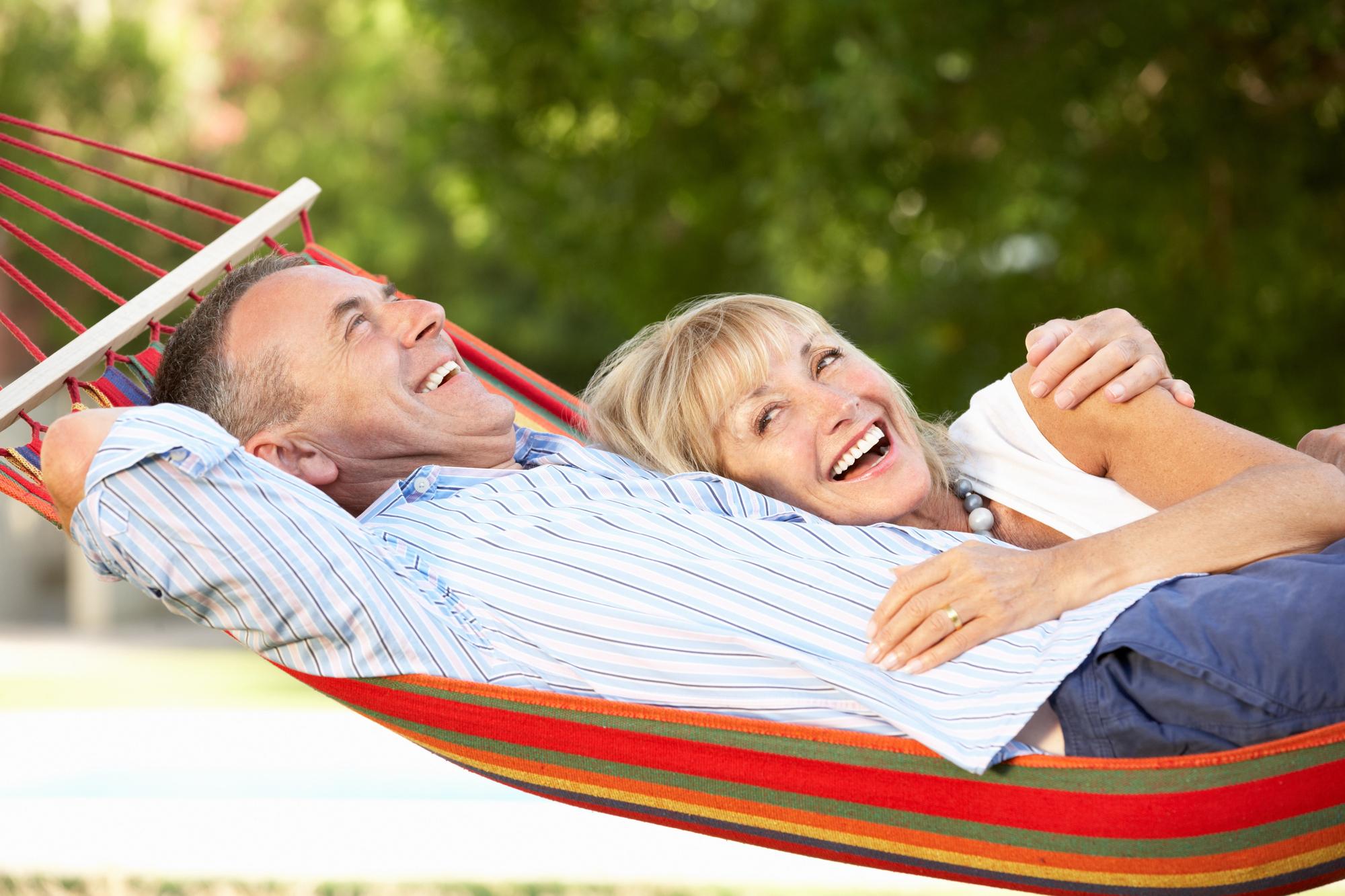 Empty Nesters Travel Guide to Travel without a Schedule: Embrace Freedom and Flexibility - Empty Nesters Relaxing in a Hammock While on Vacation