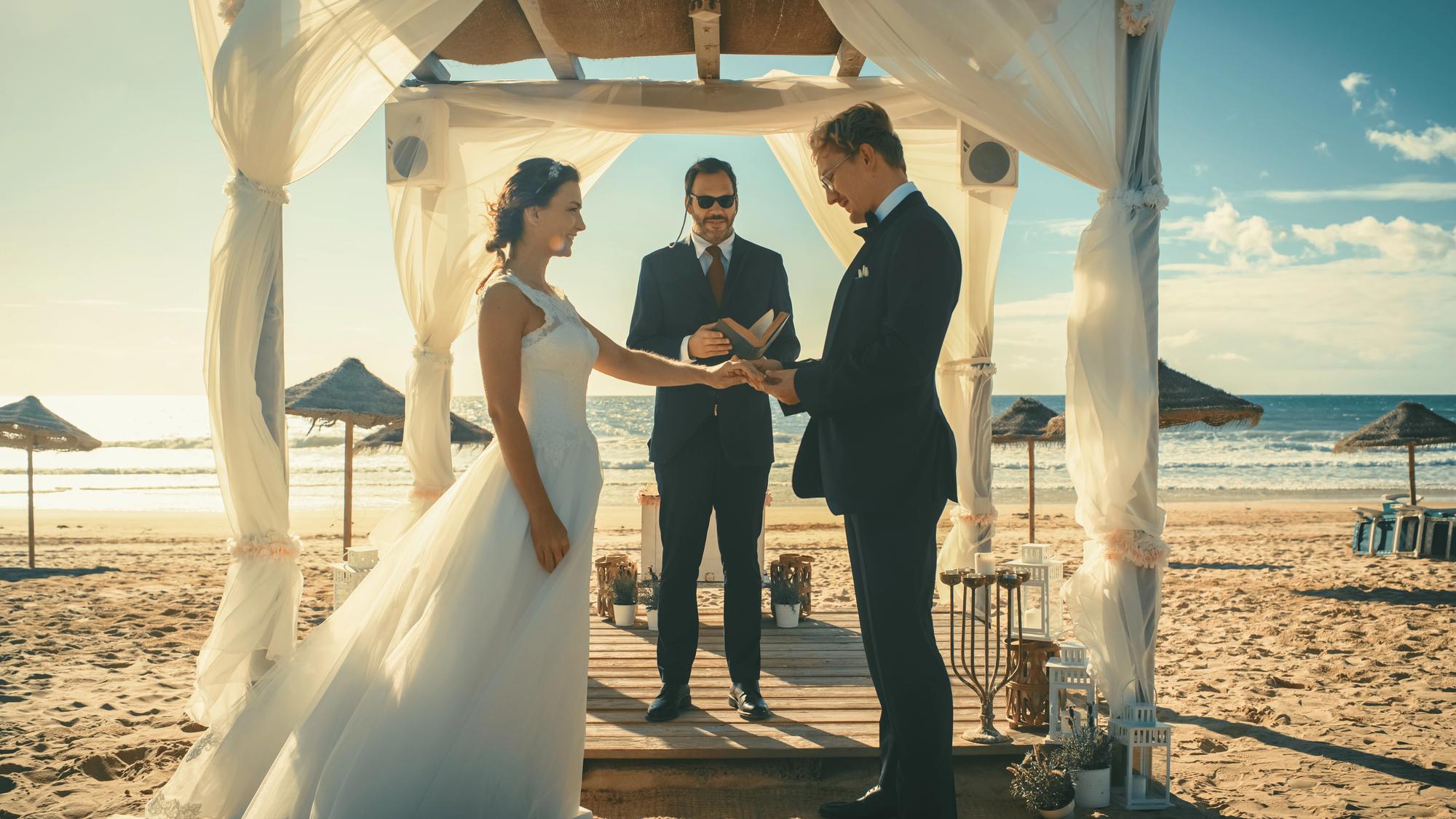 Why Hire a Travel Advisor for Your Destination Wedding? - Couple at the Altar on the Beach for Their Destination Wedding